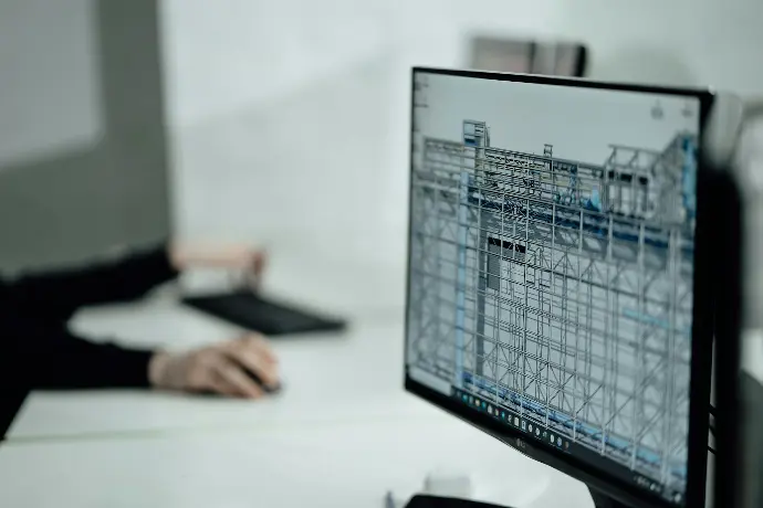 Working on structural design plans. Computer screen displaying architectural blueprints.