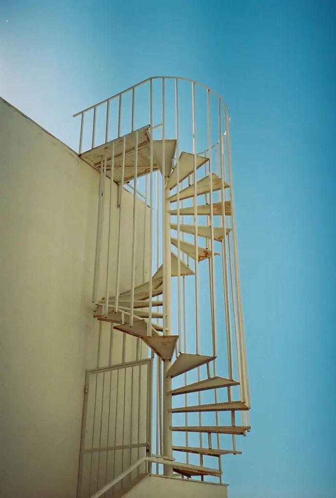 Emergency stairs white concrete building during daytime with a staircase