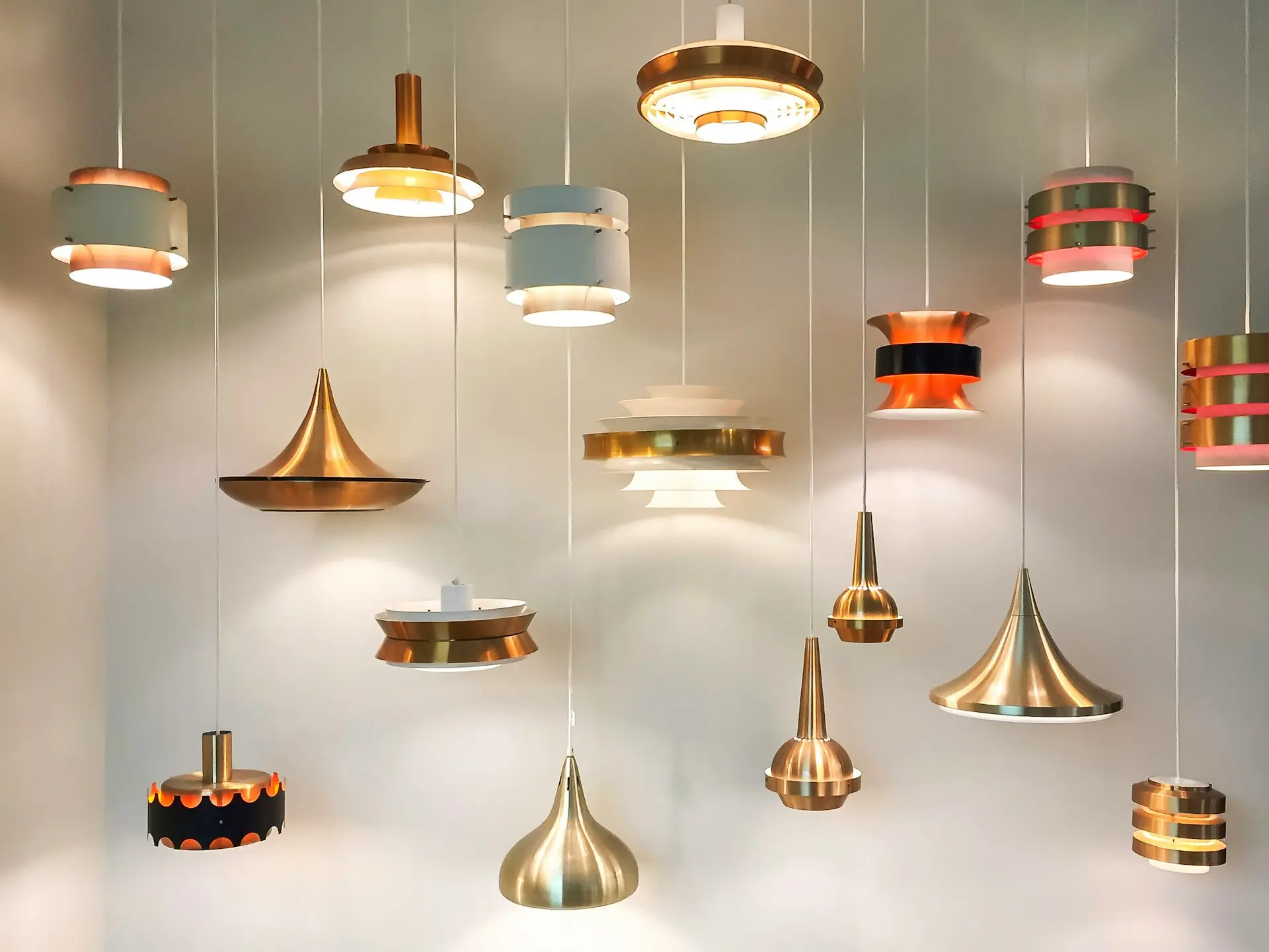 Collection of modern decorative pendant lights in various shapes and finishes, representing Guangzhou Sourcing’s lighting solutions.