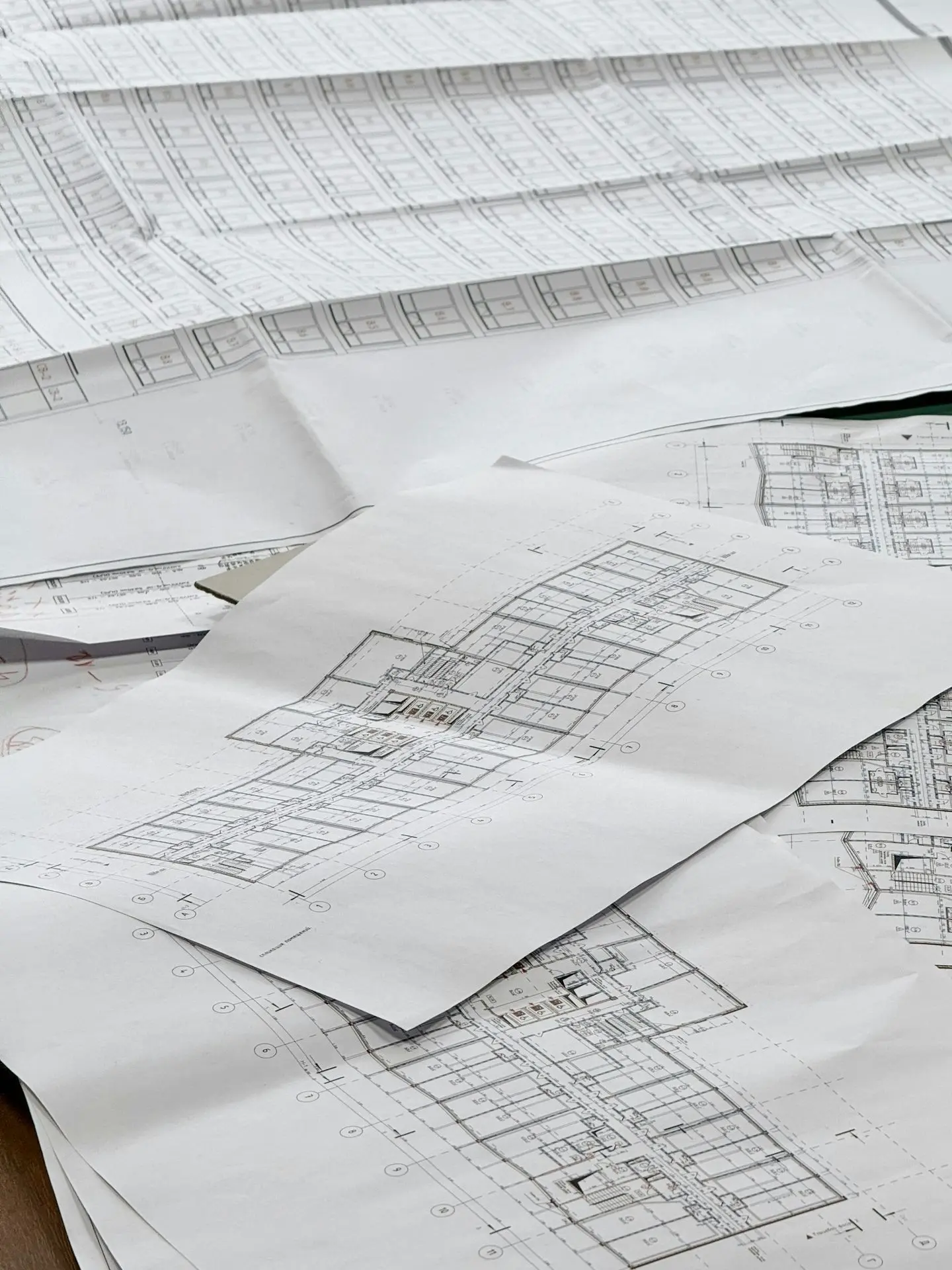 Architectural blueprints spread out on a surface.