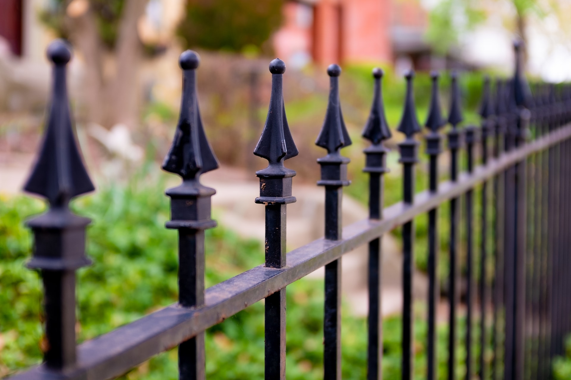 Black metal fence black metal fence near green grass during daytime