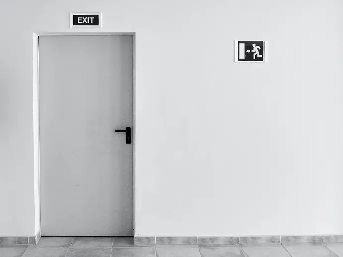 Doors closed white painted door with exit signage
