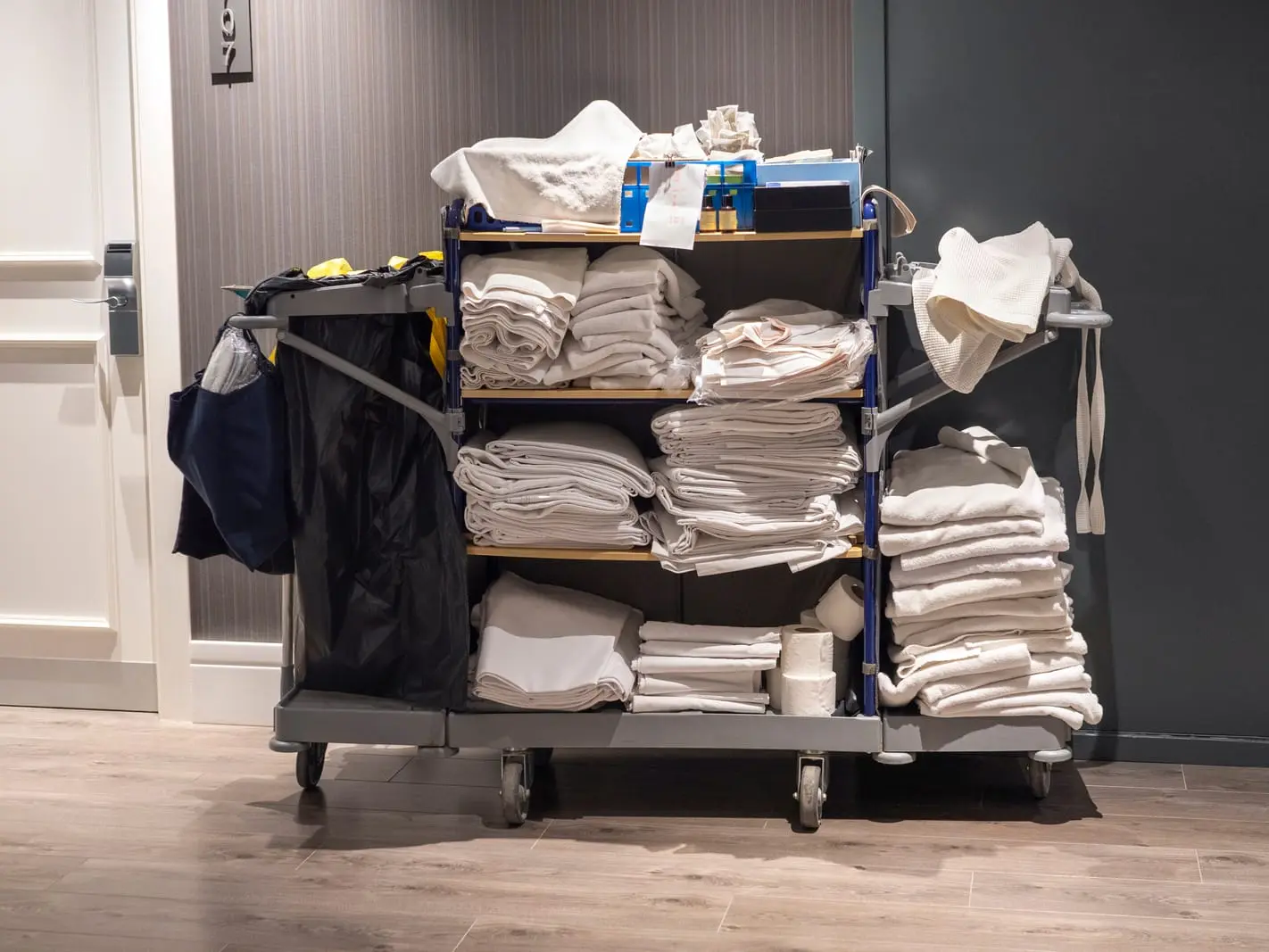 A trolley with neatly folded towels and various items.