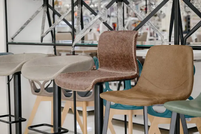 A row of chairs in a store with a counter.