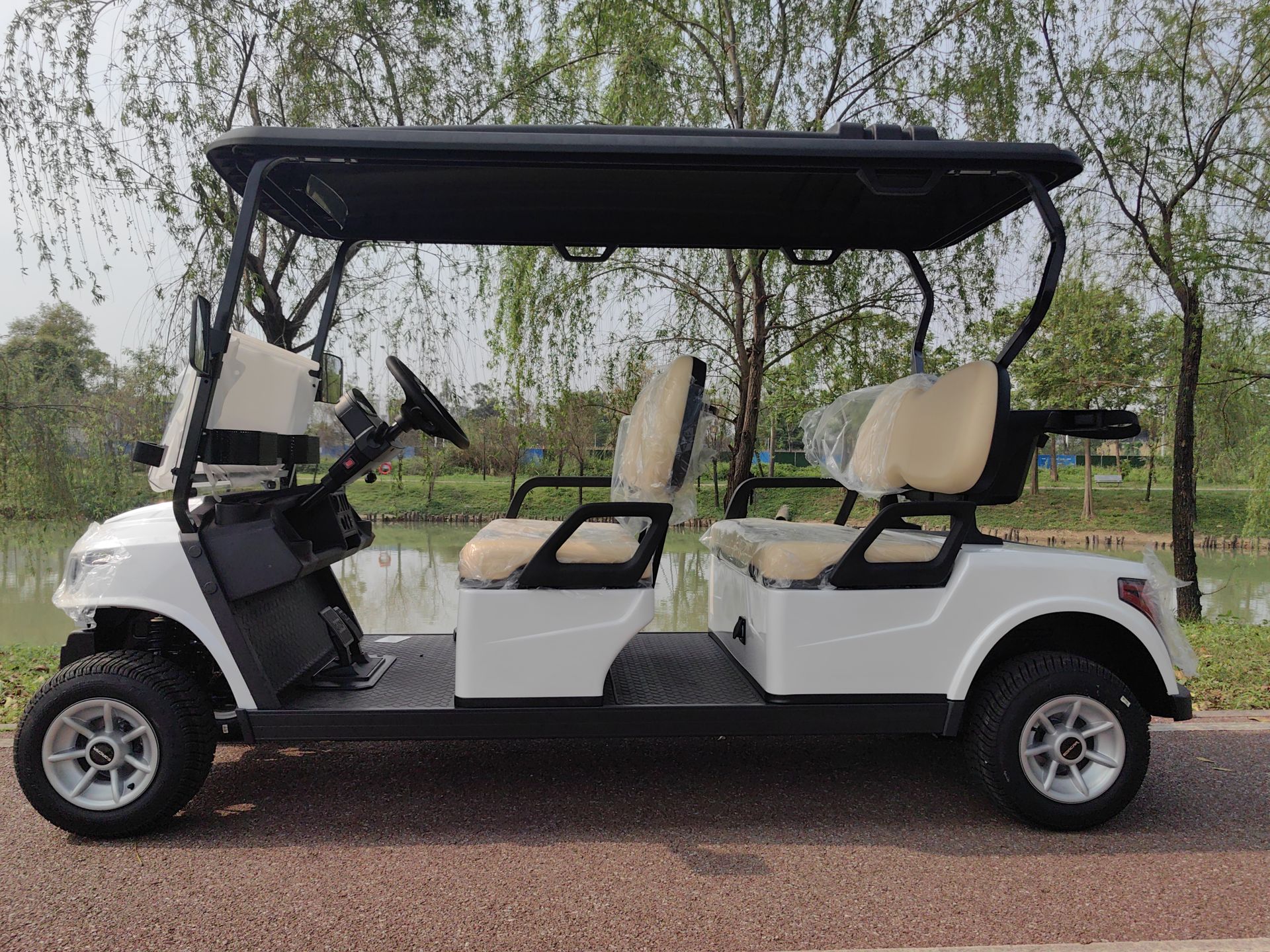 A white golf cart with beige seats