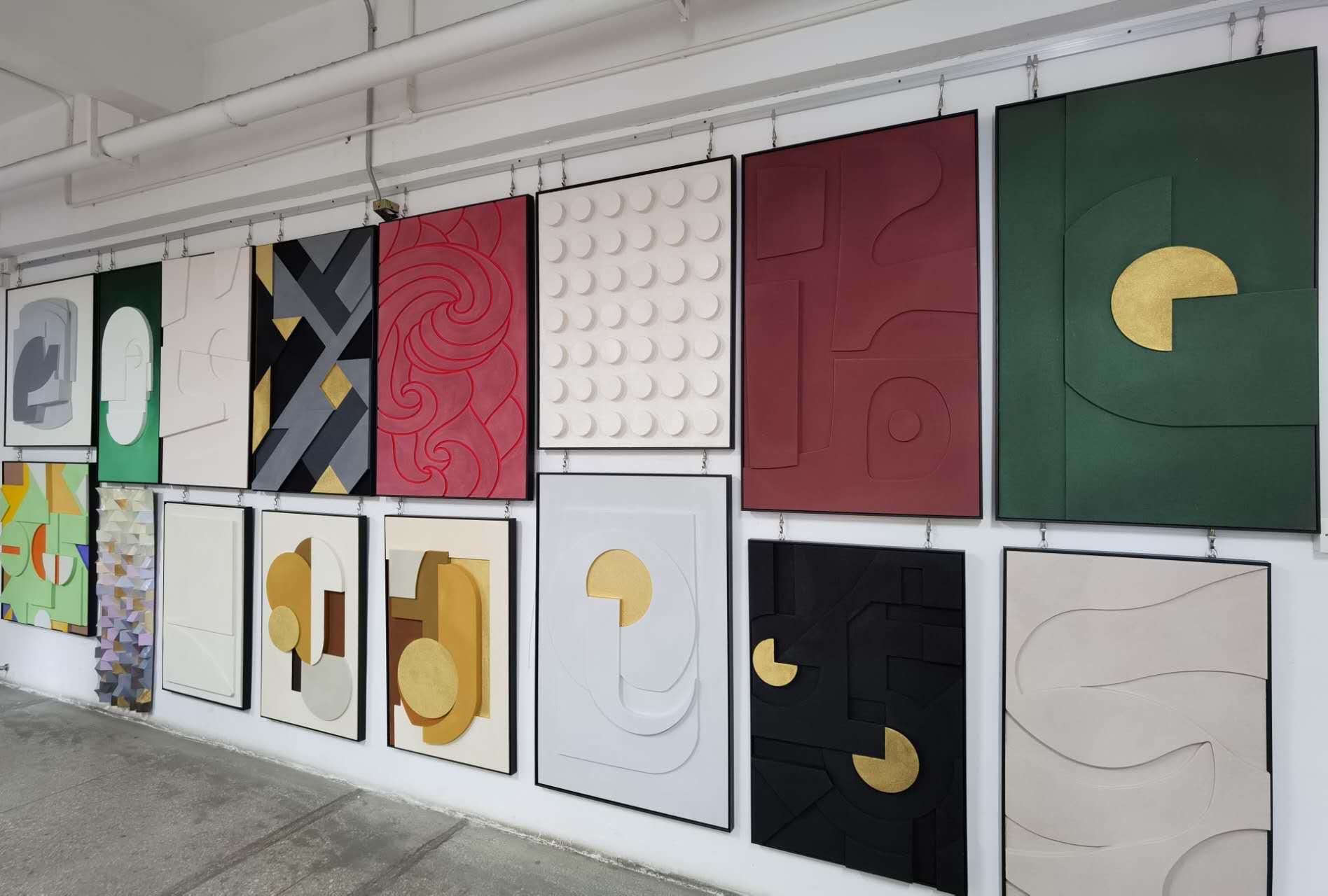 Gallery wall displaying a variety of abstract artworks