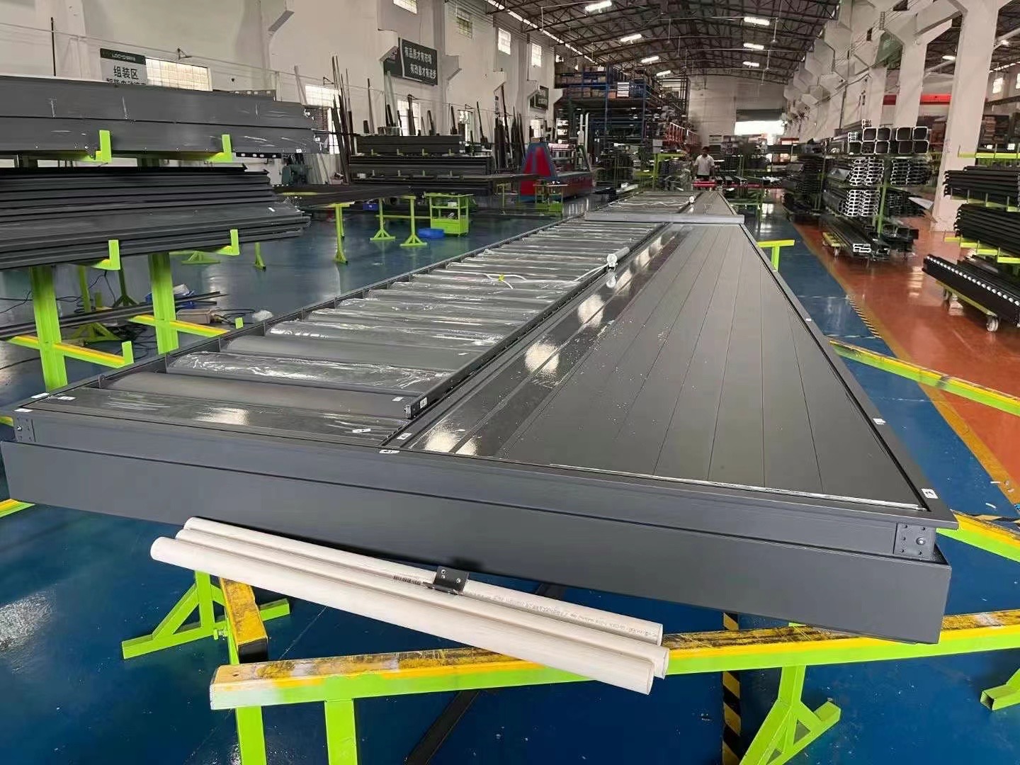 Assembly line for modern pergolas in a factory setting in China, showcasing various components.