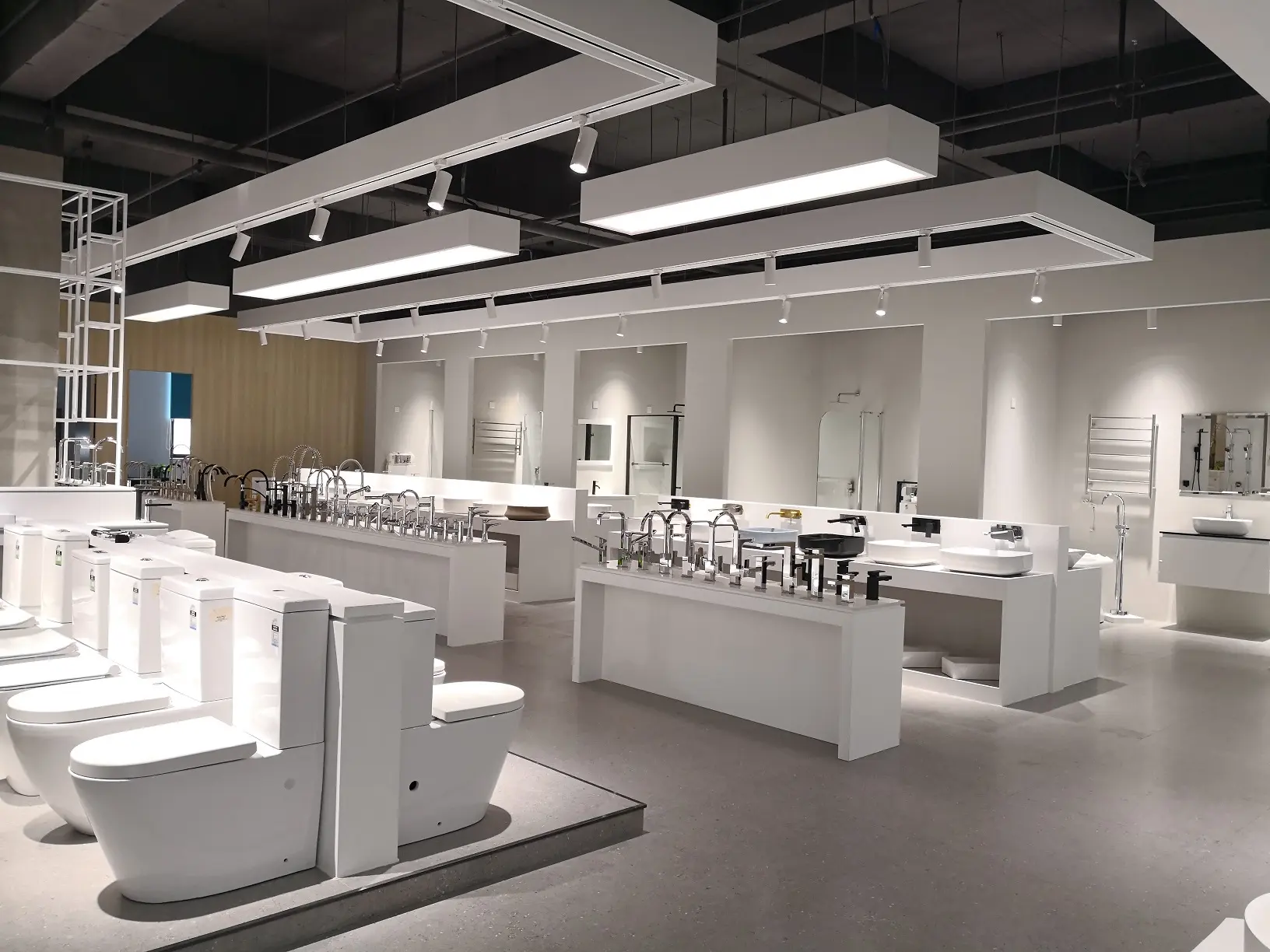 A well-lit showroom showcasing a wide range of sanitary ware including toilets, sinks, and faucets.