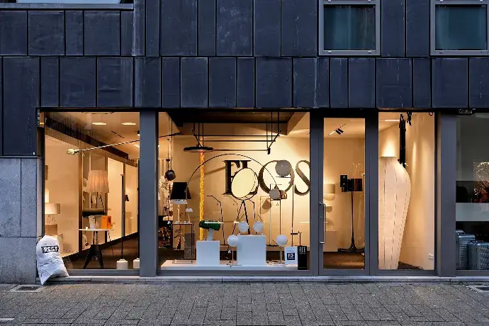 Exploring Facade Glazing and Storefront Sourcing Opportunities in China A modern storefront displaying various lighting fixtures and decorative elements through large glass windows.