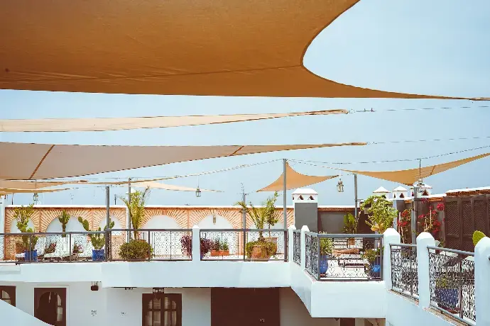 Versatile Tensile Fabric Coverings: Sourcing Solutions in China Overview of a terrace featuring tensile fabric coverings for shade, adorned with plants and decorative elements.