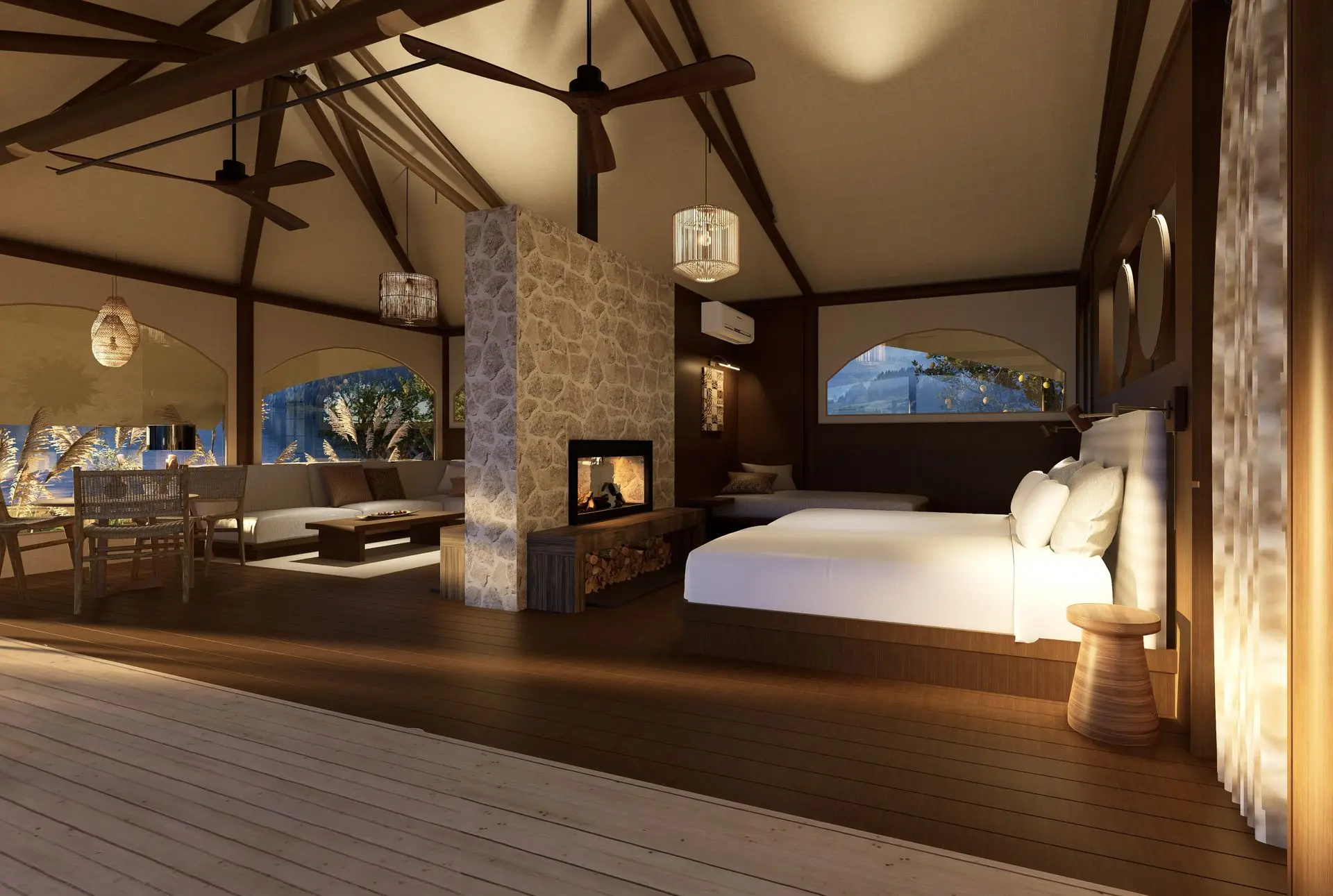 A spacious accommodation tent interior featuring two beds, a cozy seating area, a stone fireplace