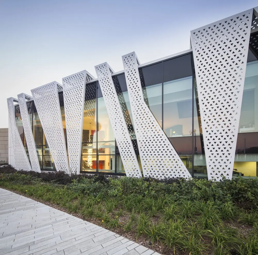 Sleek aluminum facade with a contemporary design featuring geometric patterns and reflective surfaces.