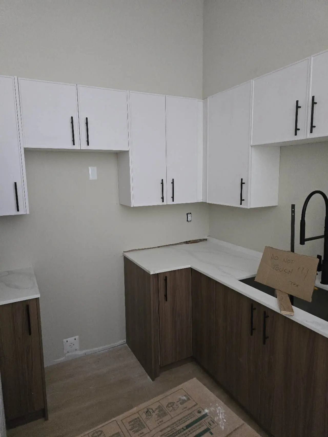 Kitchen space with white and wood cabinets