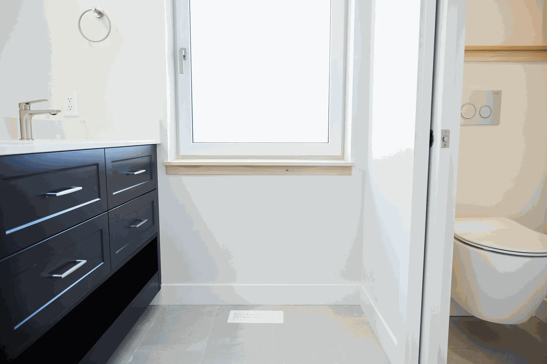  Modern bathroom featuring a dark vanity with a sink