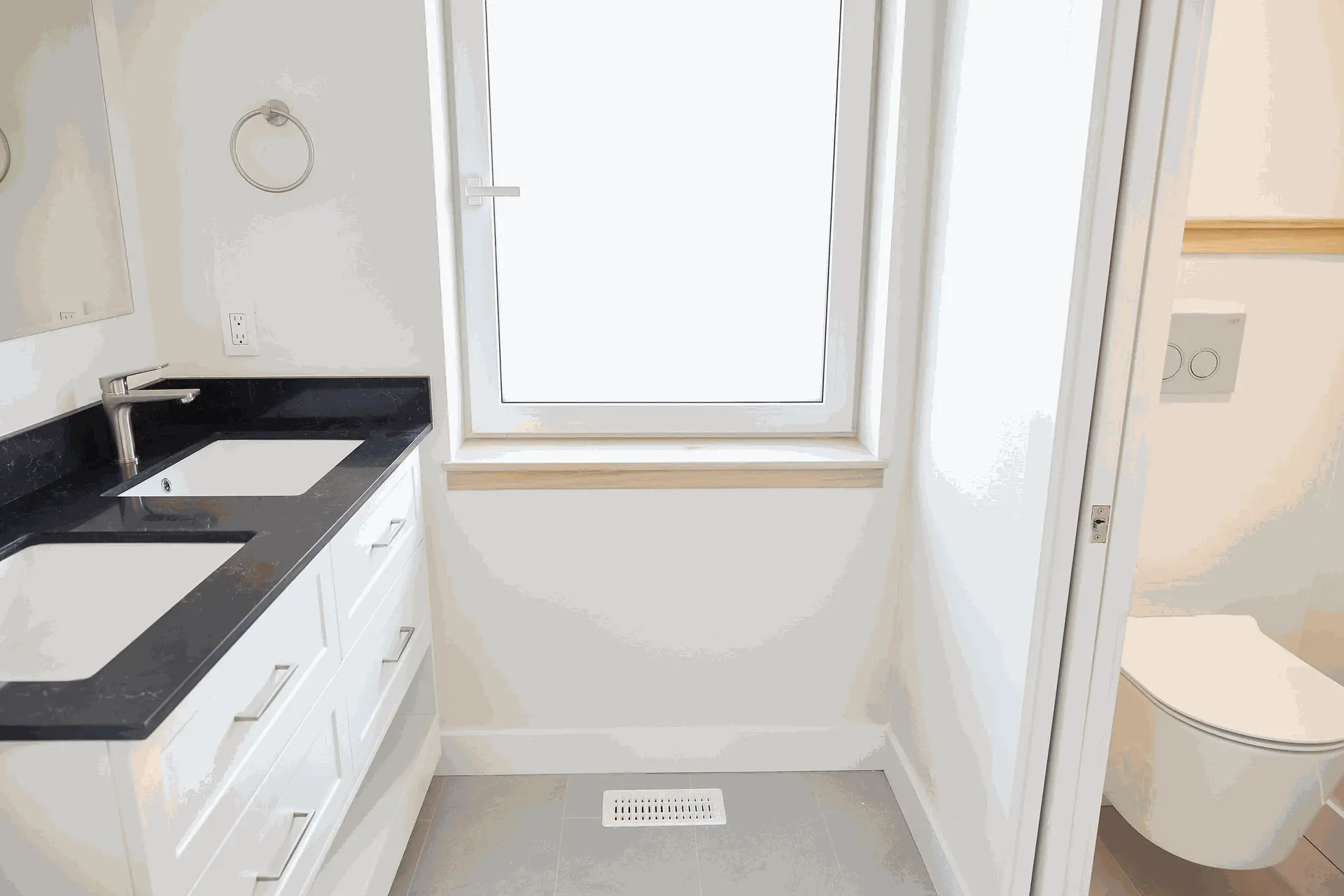 Stylish vanity unit featuring dual sinks, modern faucet, and clean white cabinetry.