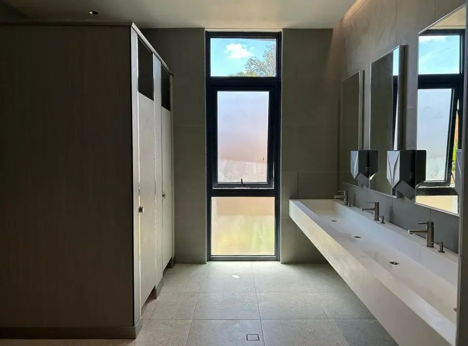 Contemporary bathroom at SJSM Pre-Med featuring modern fixtures, spacious vanities, and well-maintained partitions.