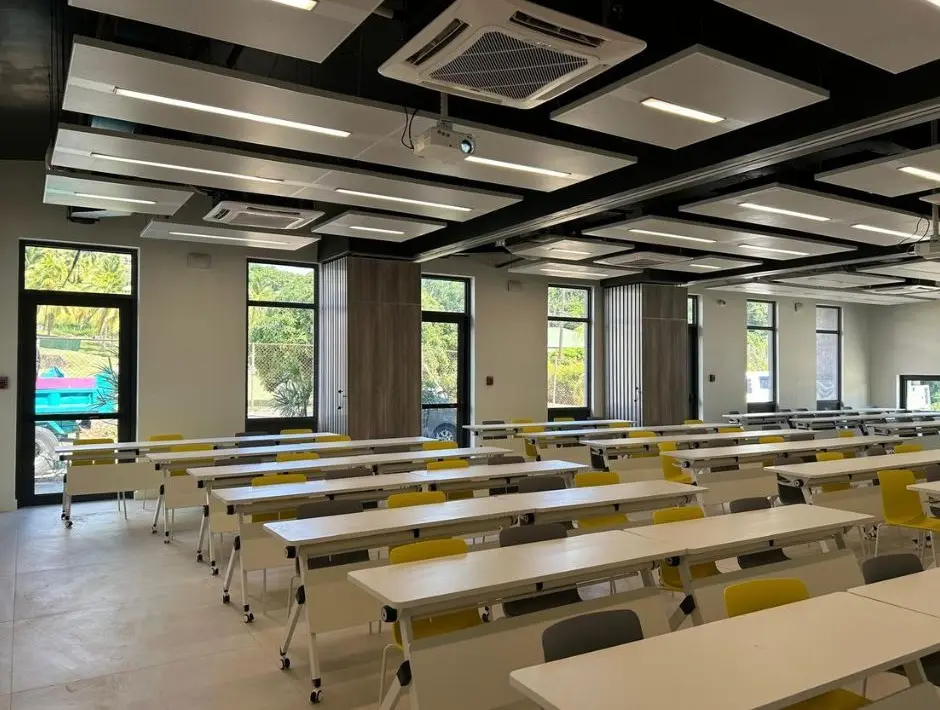 Spacious and modern classroom at SJSM Pre-Med, designed with movable tables, large windows for natural light, and contemporary ceiling fixtures.