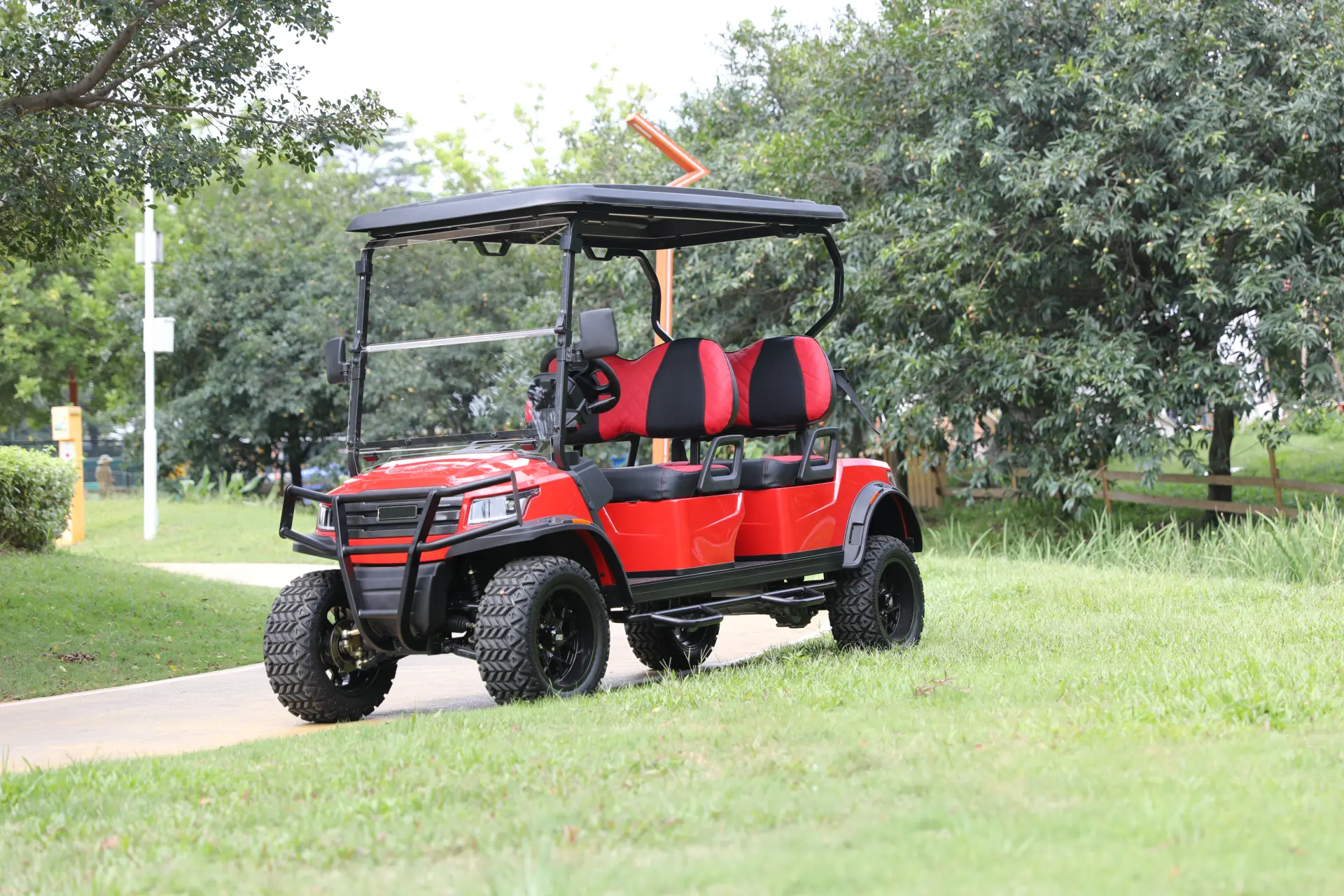 his red golf cart is built for adventure, featuring rugged tires and ample seating for a fun ride in parks or golf courses. A red golf cart with comfortable seating, designed for off-road use.