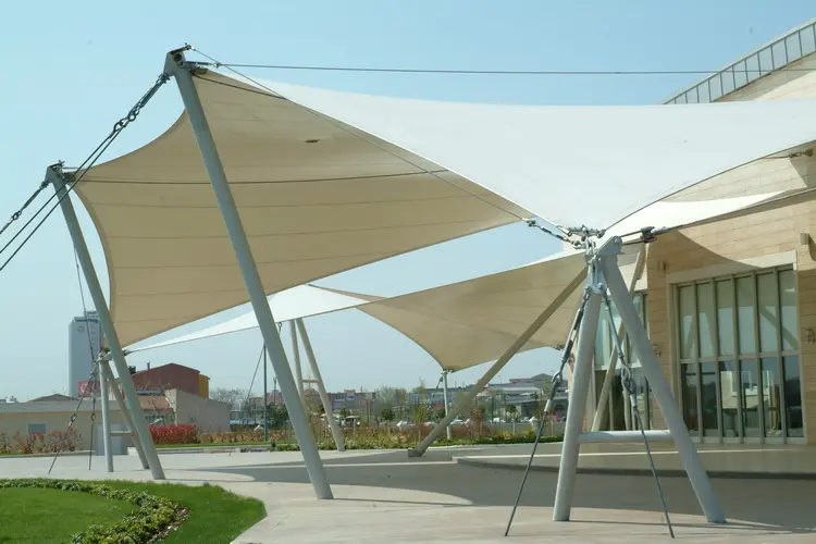 ensile fabric shade canopies supported by steel poles outside a building, modern architectural sunshade from China