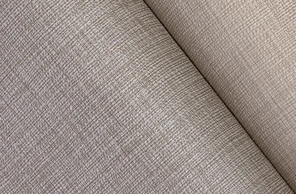 Beige crosshatch textured vinyl wall covering folded for display, showing a durable and modern design for commercial use like hotels and offices.