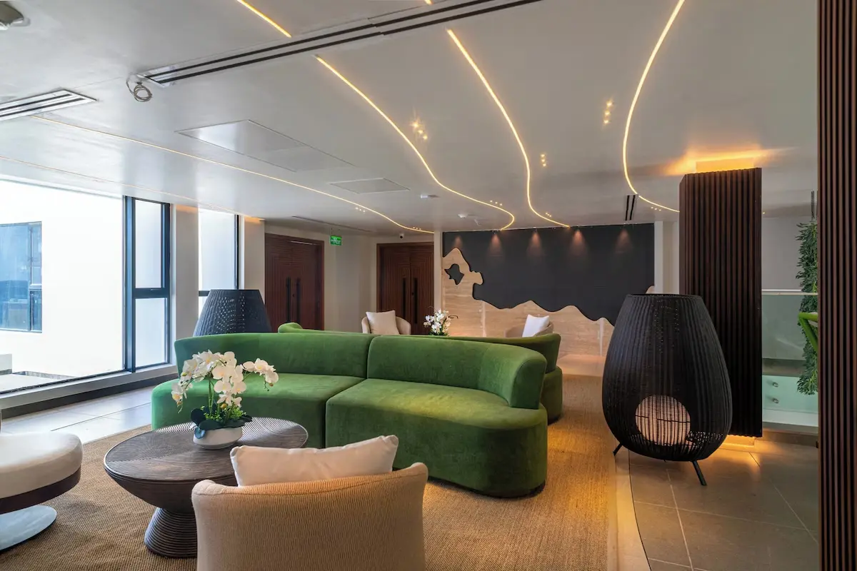 Modern Hotel Common Area Design - GZS Furnishings Wide shot of the hotel lobby seating area emphasizing the sleek design, accent lighting, and variety of comfortable seating arrangements, all GZS-supplied.