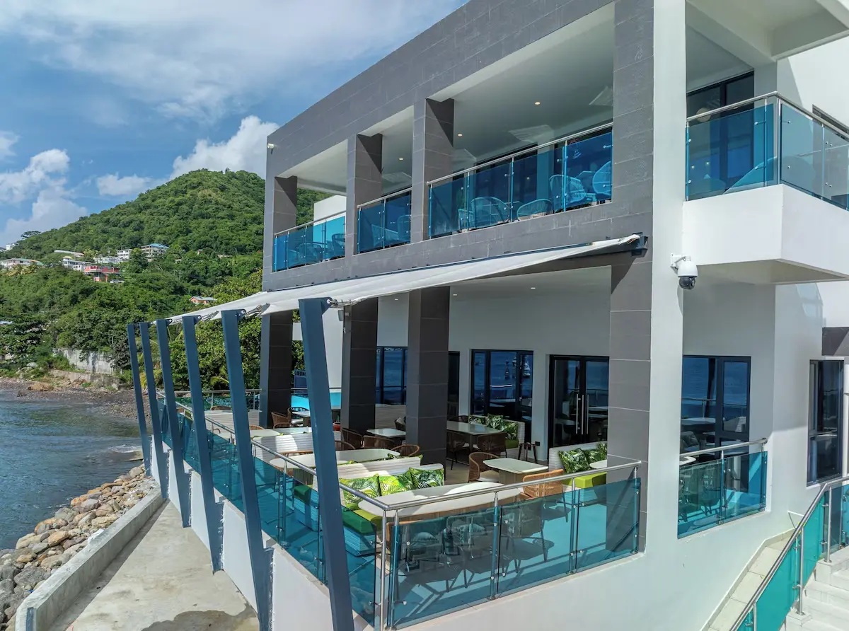 Ocean Oasis Hotel with Tensile Canvas Canopy and Modern Concrete Design Ocean Oasis Hotel exterior featuring tensile canvas shade structures, glass railings, and reinforced concrete design