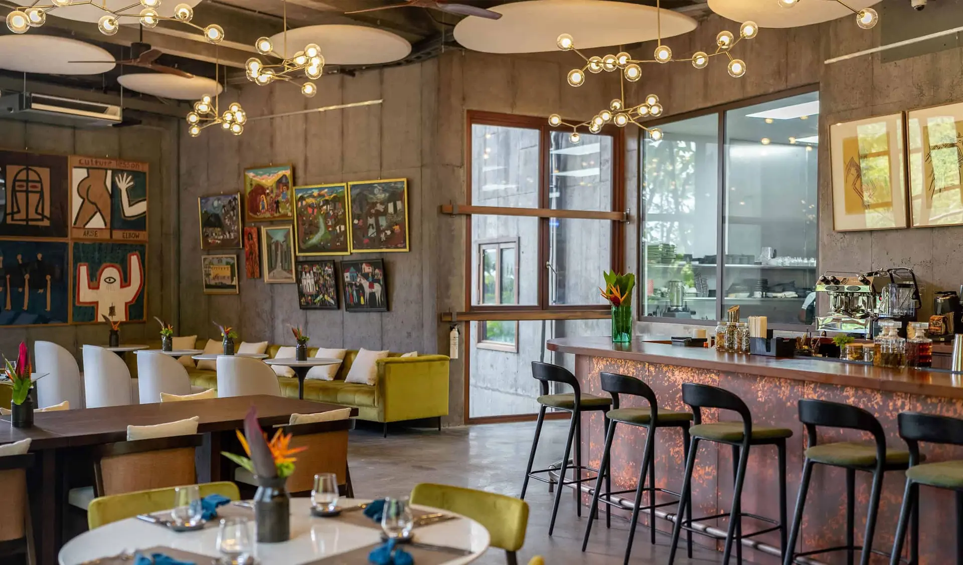 Bespoke restaurant interior with custom-designed chairs, wall art, and architectural lighting sourced from China.