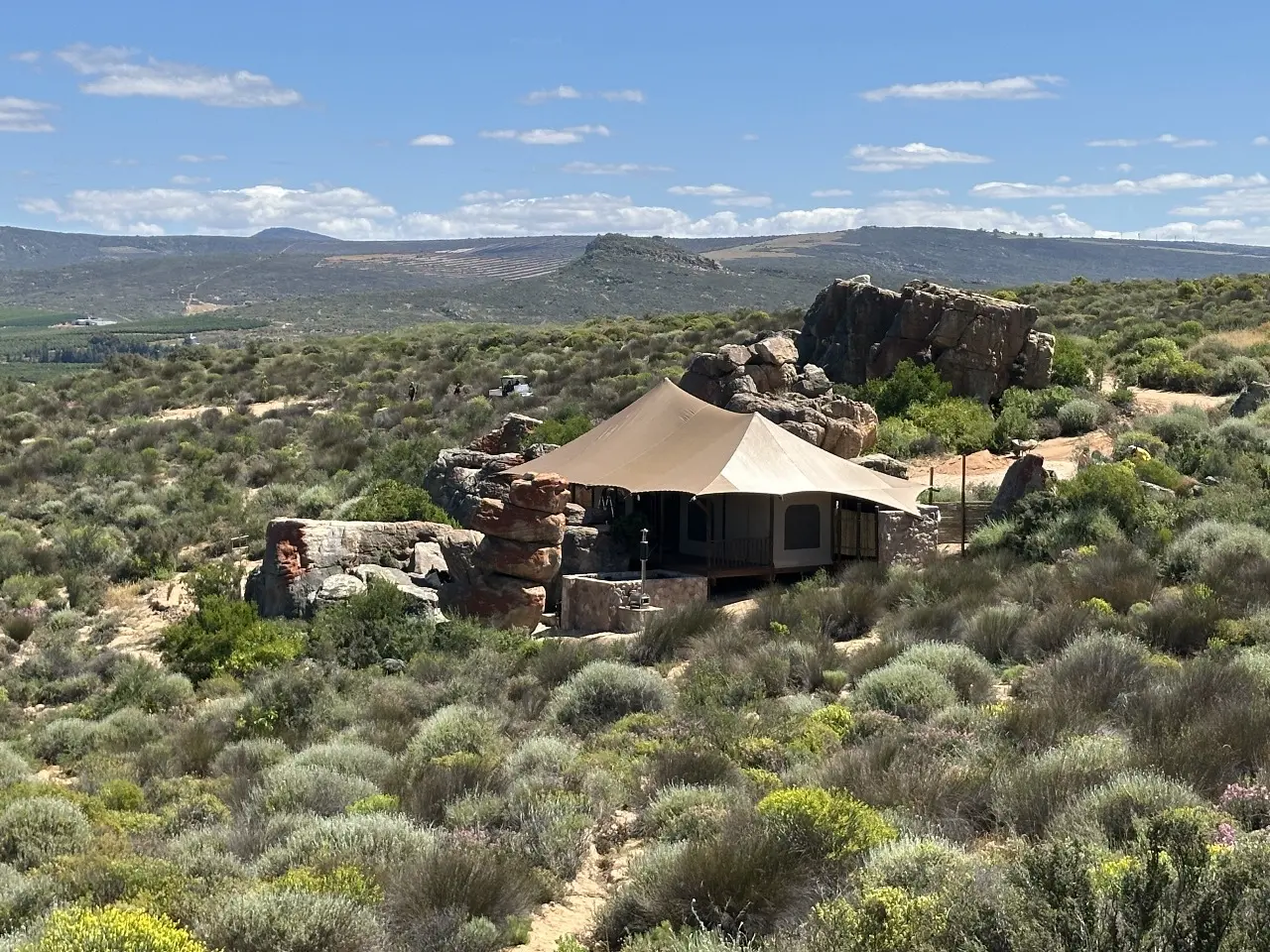 GZS sourced elevated Yamu tent villa featuring tensile canvas roofing and natural stone cladding.