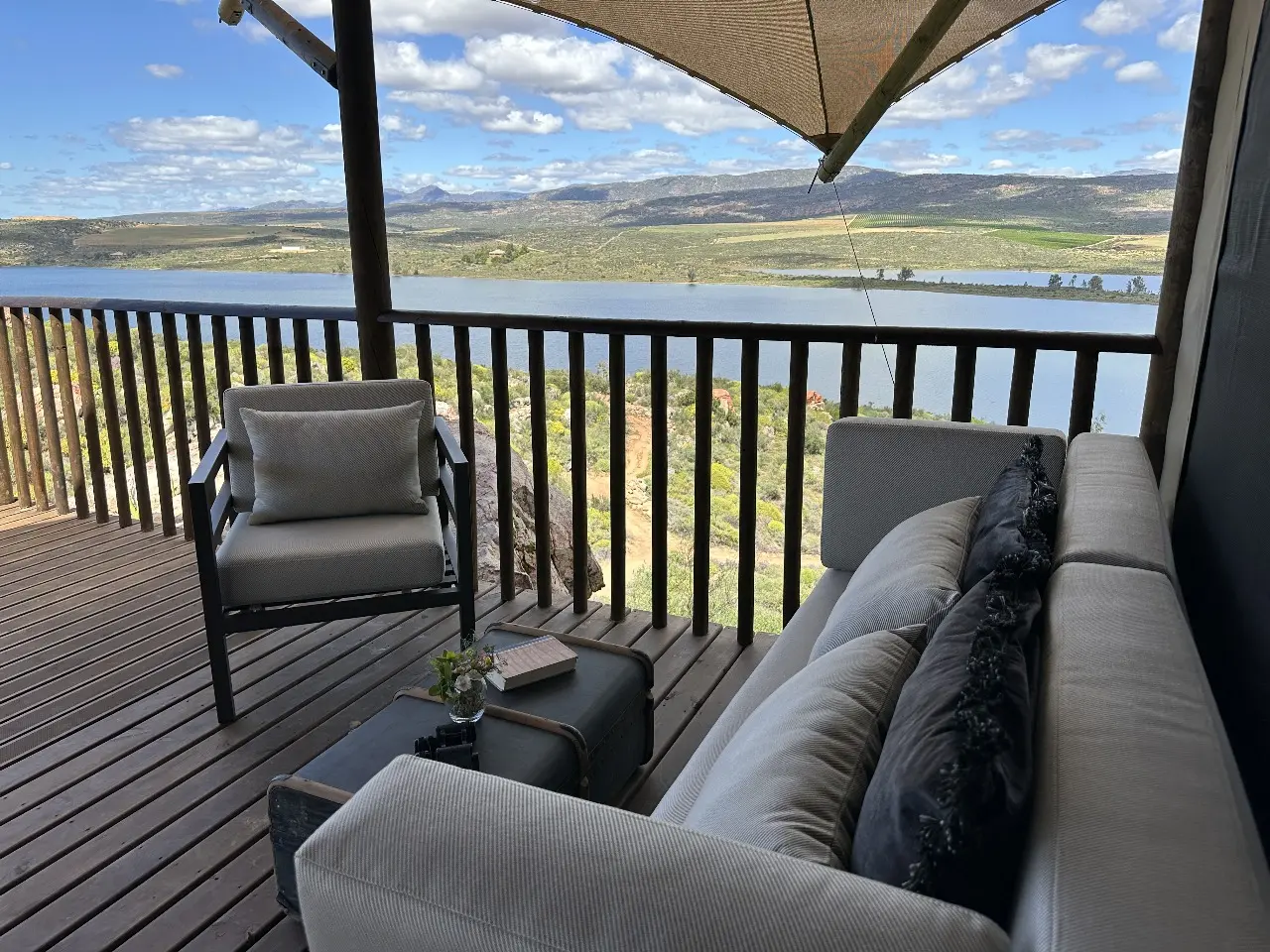 Outdoor sofa and armchair set on Yamu deck with wooden flooring and scenic mountain views.