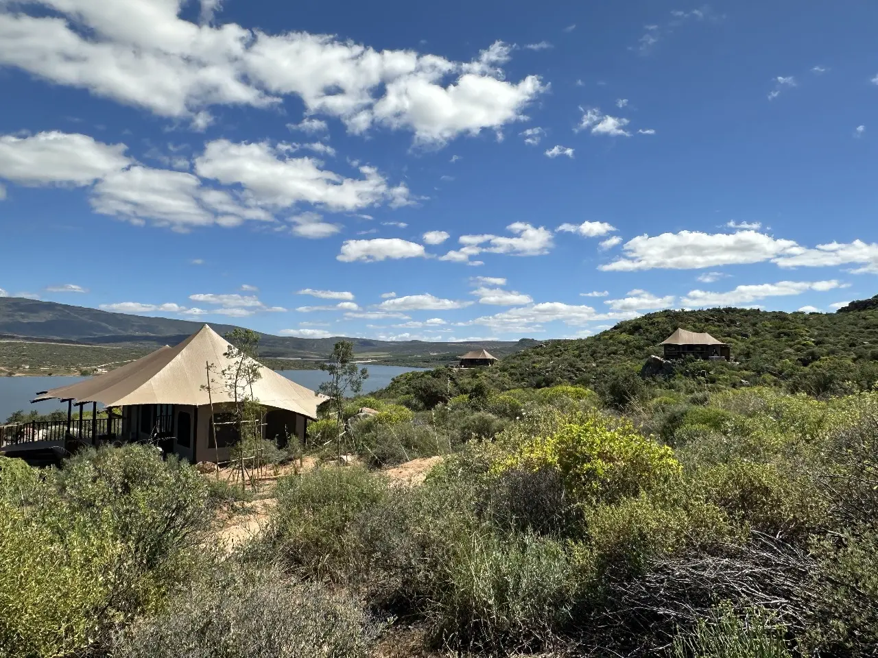 GZS sourced eco-luxury Yamu tent with tensile fabric canopy overlooking mountains and lake views.