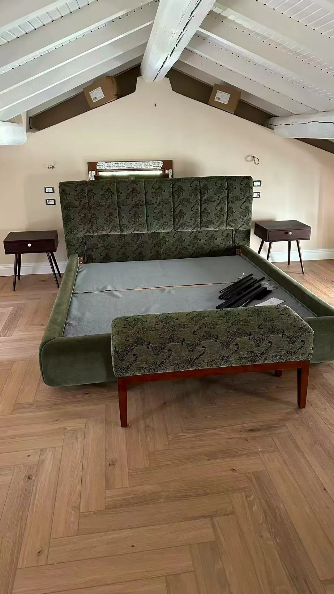 GZS sourced green upholstered bed frame with wooden legs in a Lake Como Boutique Hotel attic suite.