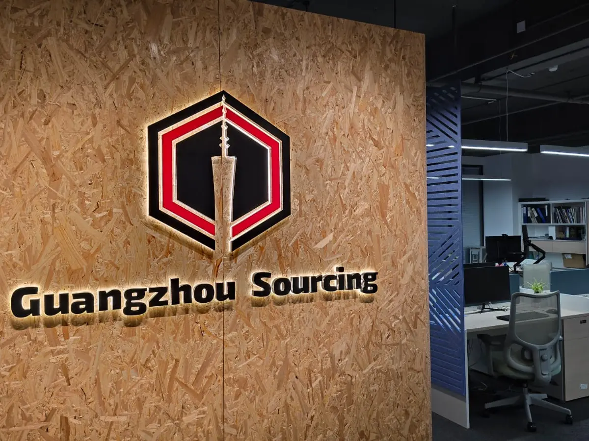 Guangzhou Sourcing office entrance with illuminated company logo, representing trusted China sourcing process and on-ground support.