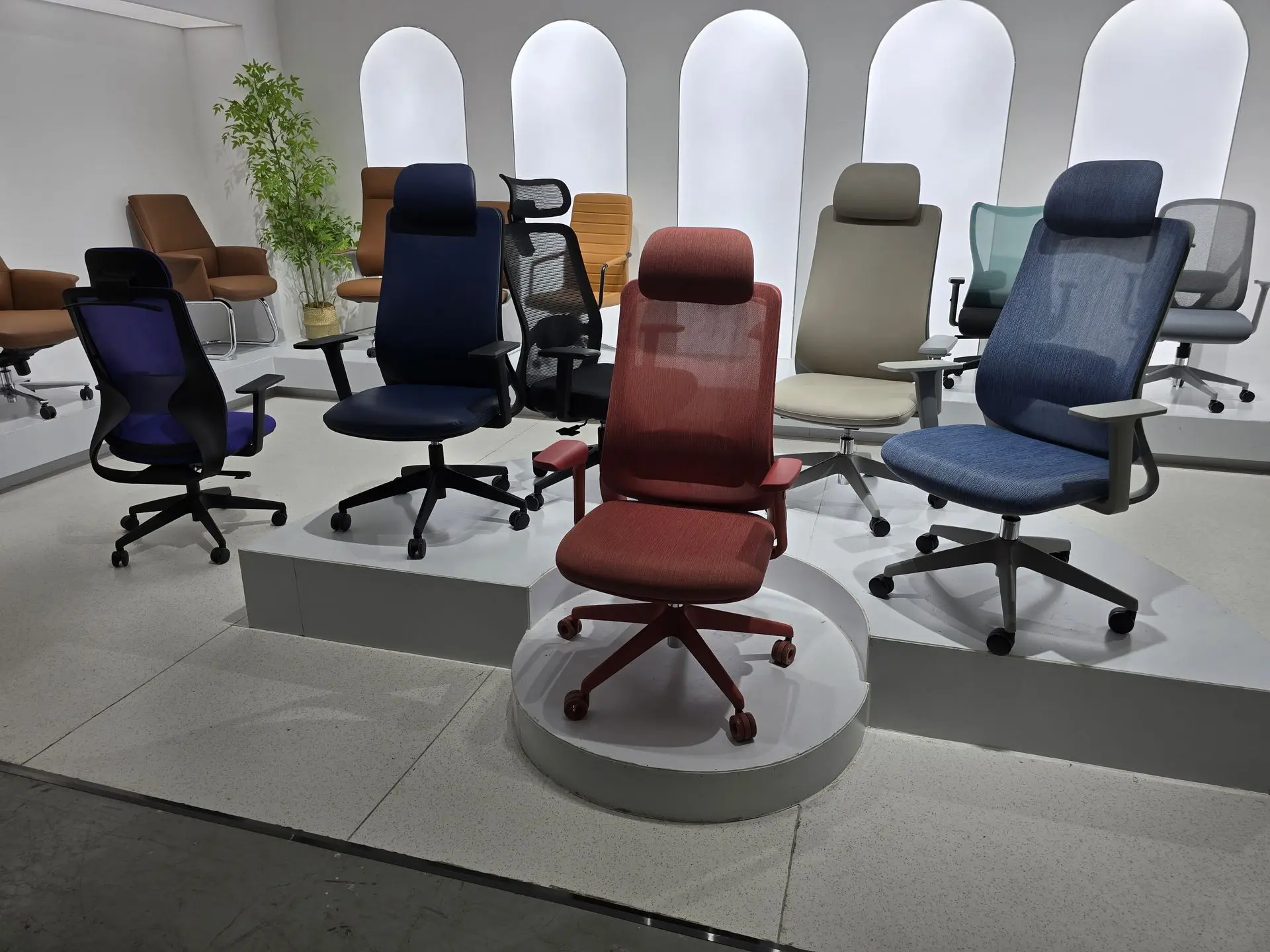 Display of modern ergonomic office chairs in various colors sourced from China.