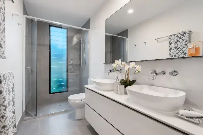 Modern bathroom featuring premium sanitary ware sourced from China, including vessel sinks, wall-mounted faucets, and a glass shower enclosure.