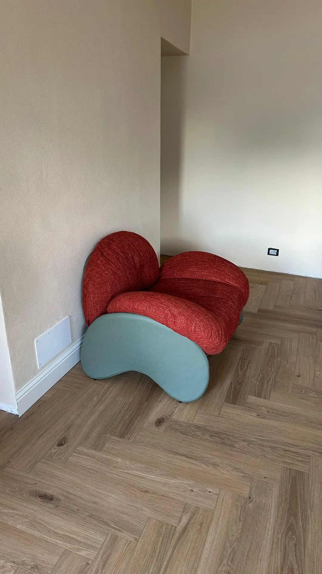 Red modern lounge chairs with sculptural bases sourced by Guangzhou Sourcing for the Lake Como Boutique Hotel.