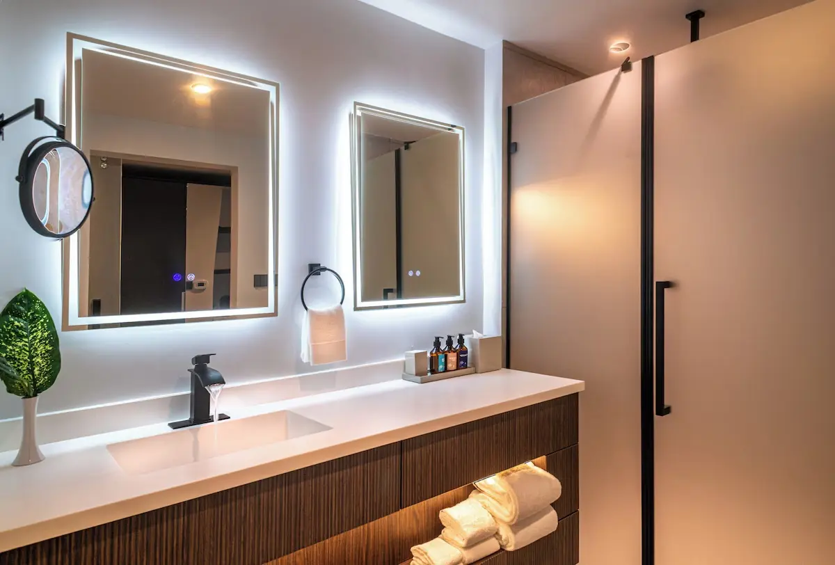 Ocean Oasis hotel sanitary ware featuring modern bathroom design with illuminated mirrors, sleek vanity, and premium fixtures