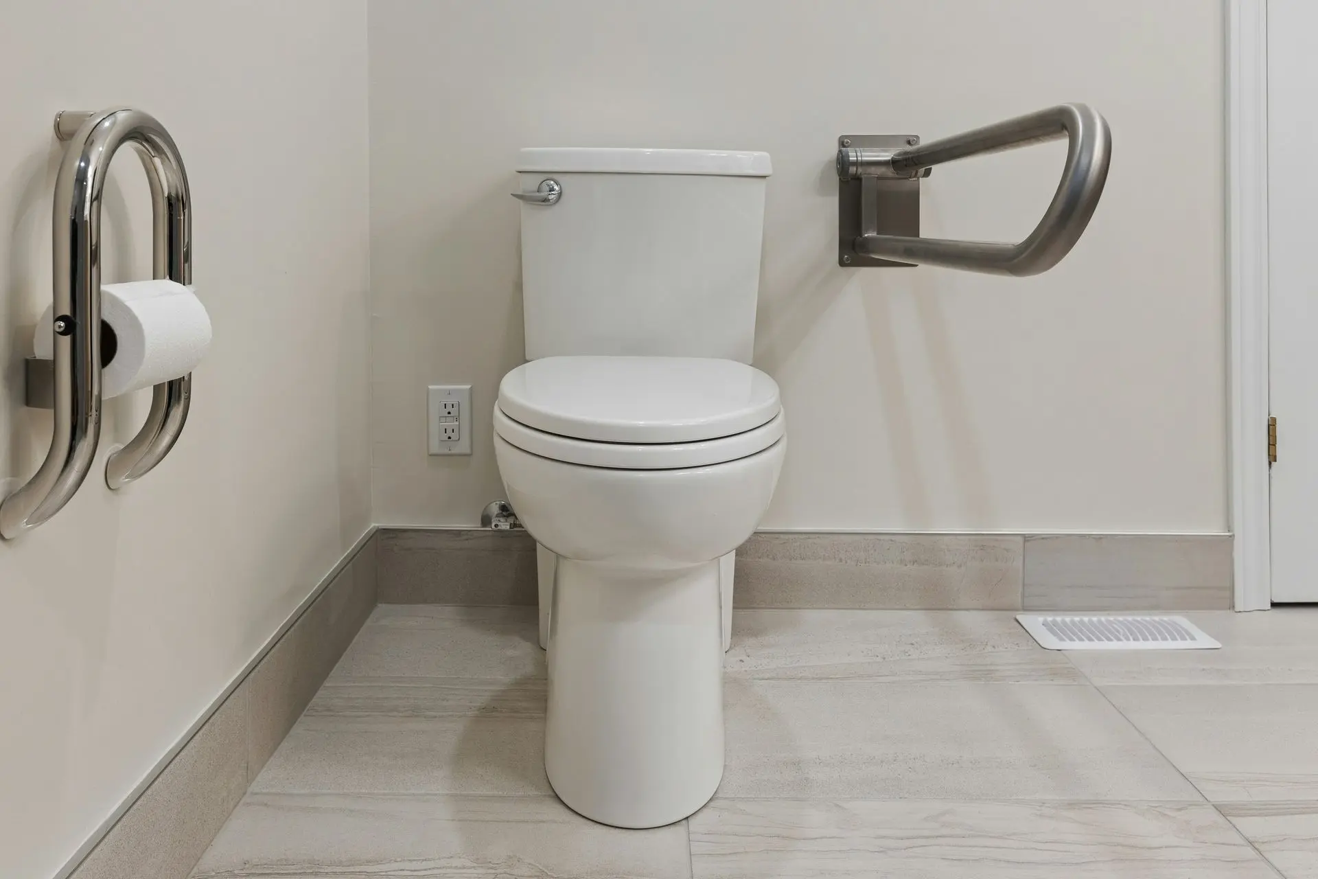 Modern ADA-compliant hotel bathroom fixture with grab bars and accessible toilet