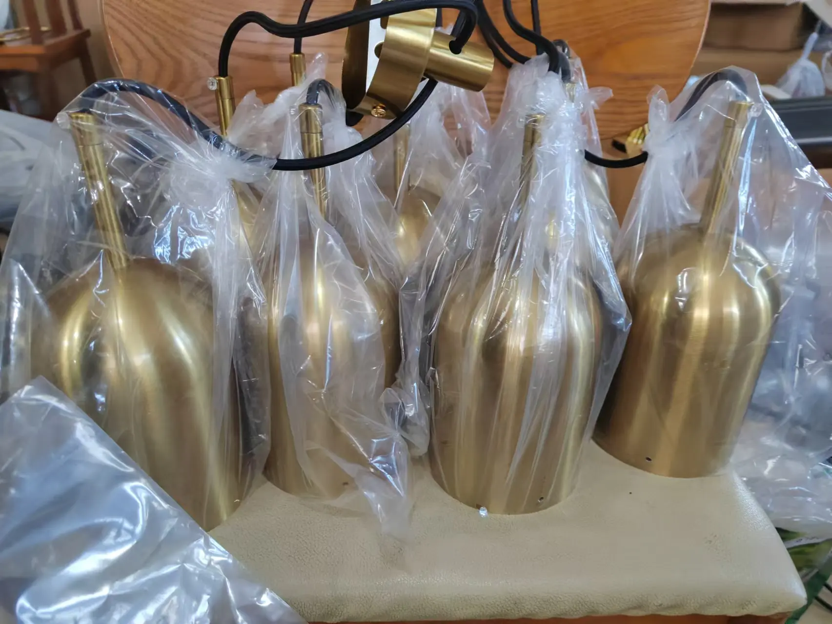 Quality inspection of finished brass lighting fixtures packaged for inspection and approval.