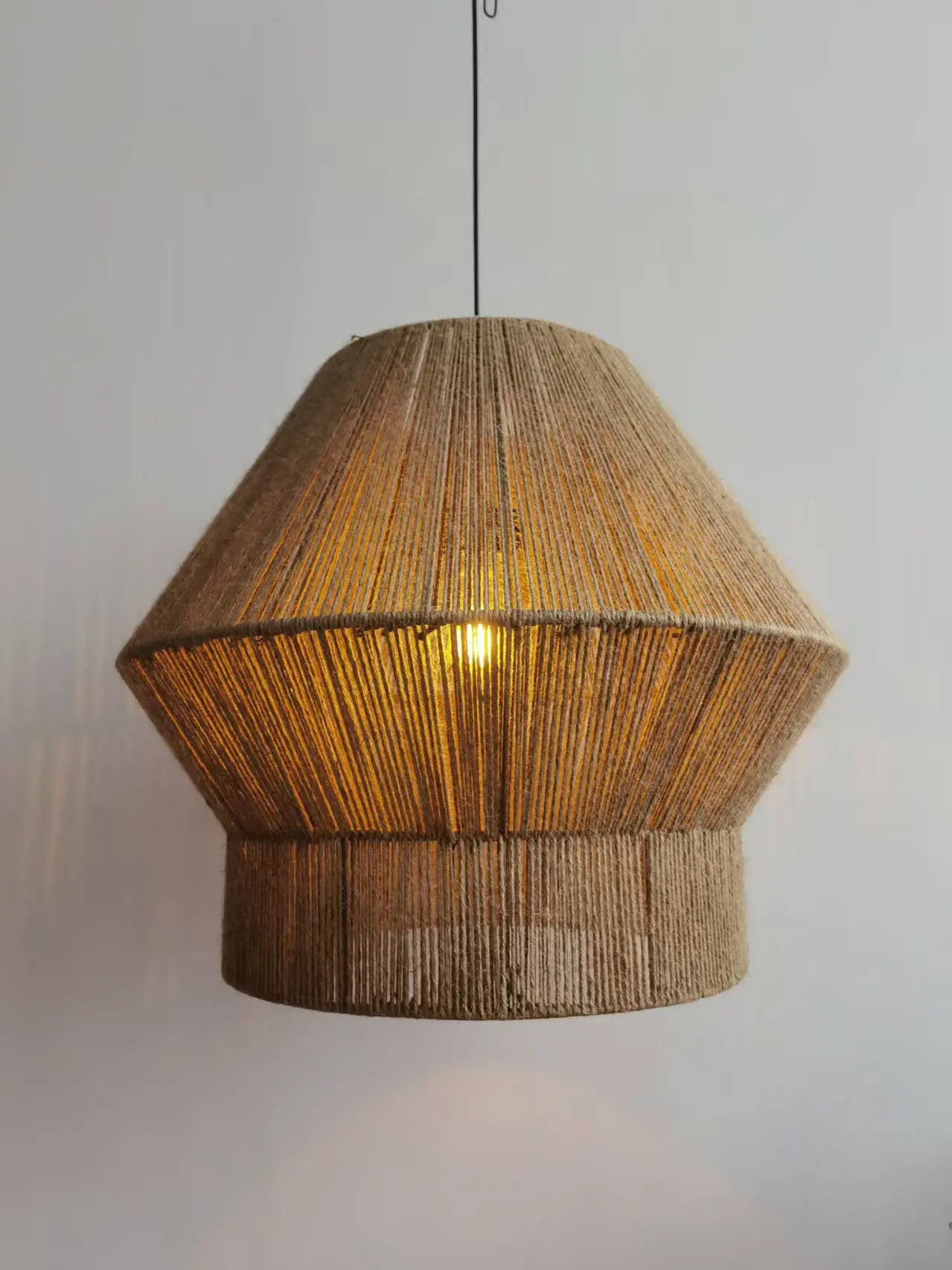 Natural woven lighting fixture glowing warm light, sourced from rattan light manufacturers in China.