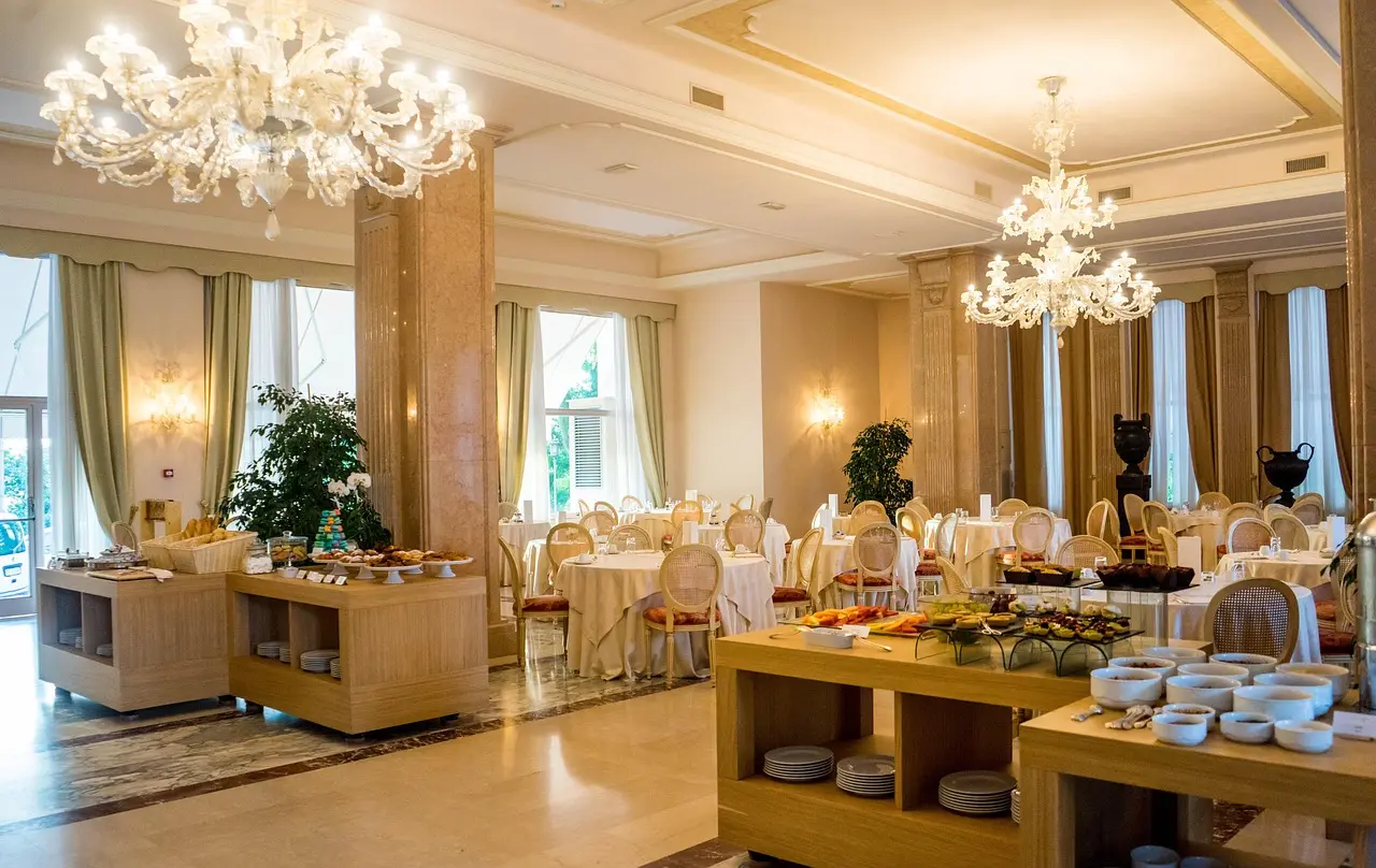 Luxury hotel dining area illuminated by elegant crystal chandeliers