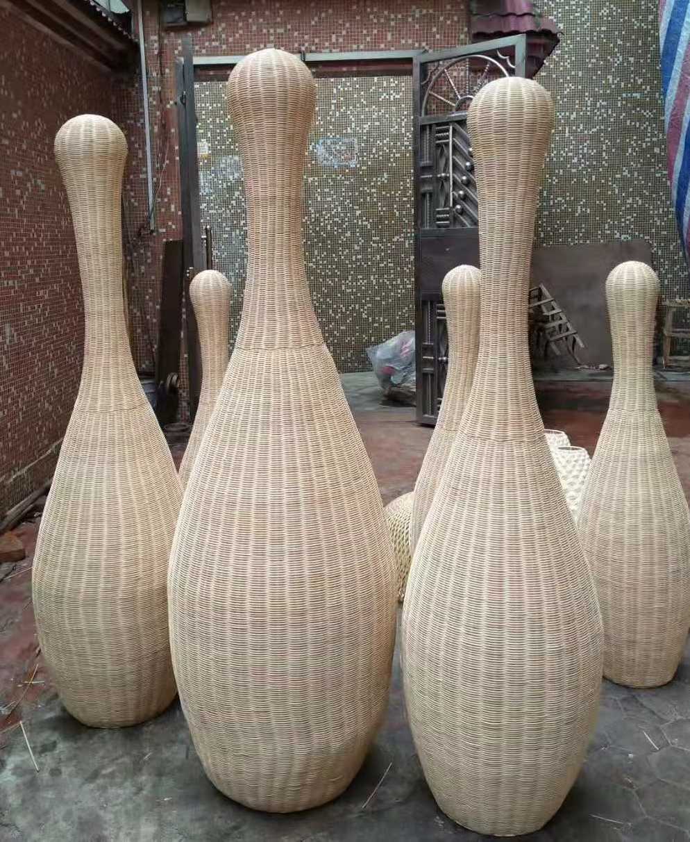 Custom-shaped rattan pendant lights in production, demonstrating size and design customization by rattan lighting manufacturers in China
