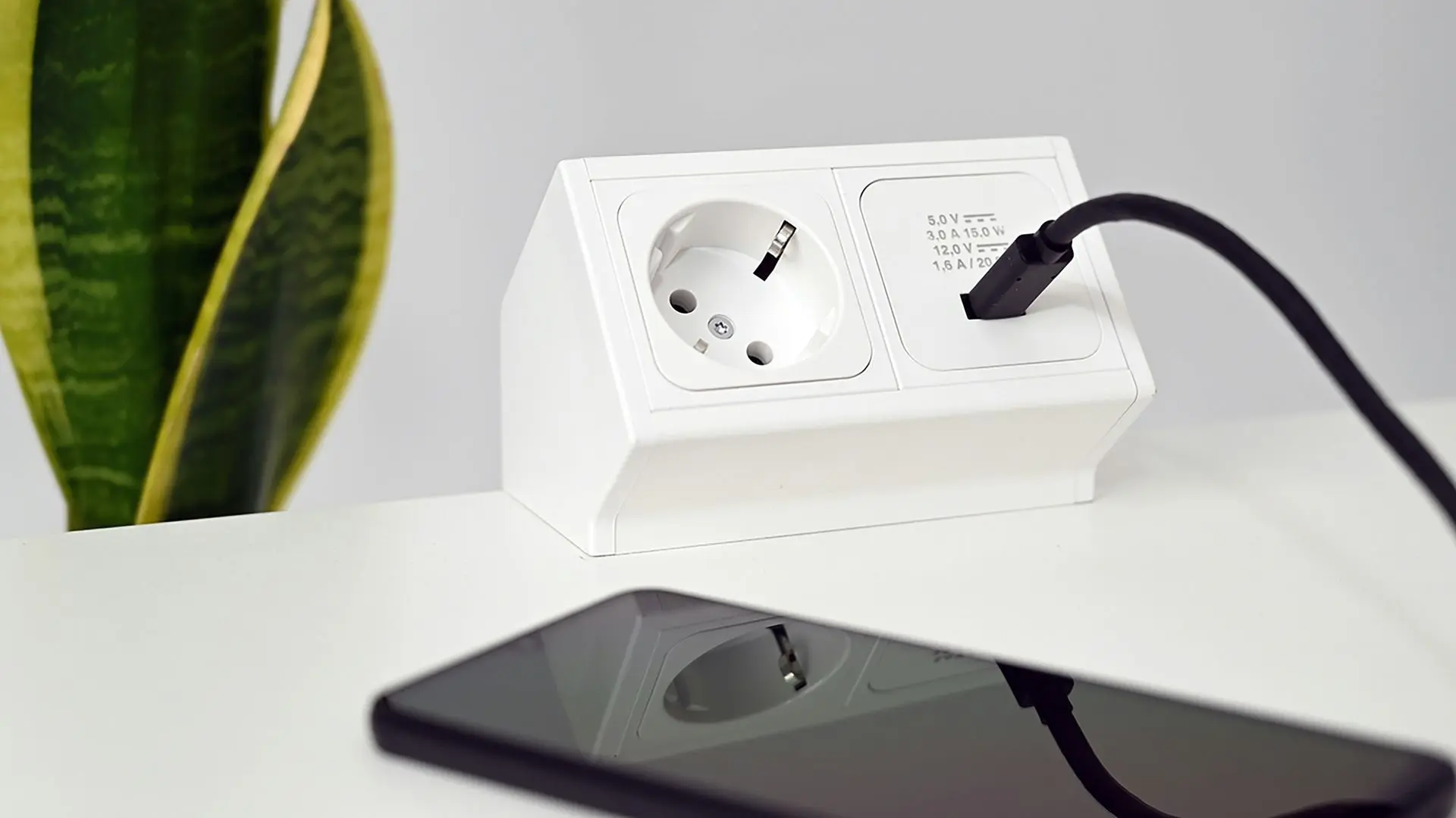 Desk-mounted power socket with USB charging port for office and hotel use