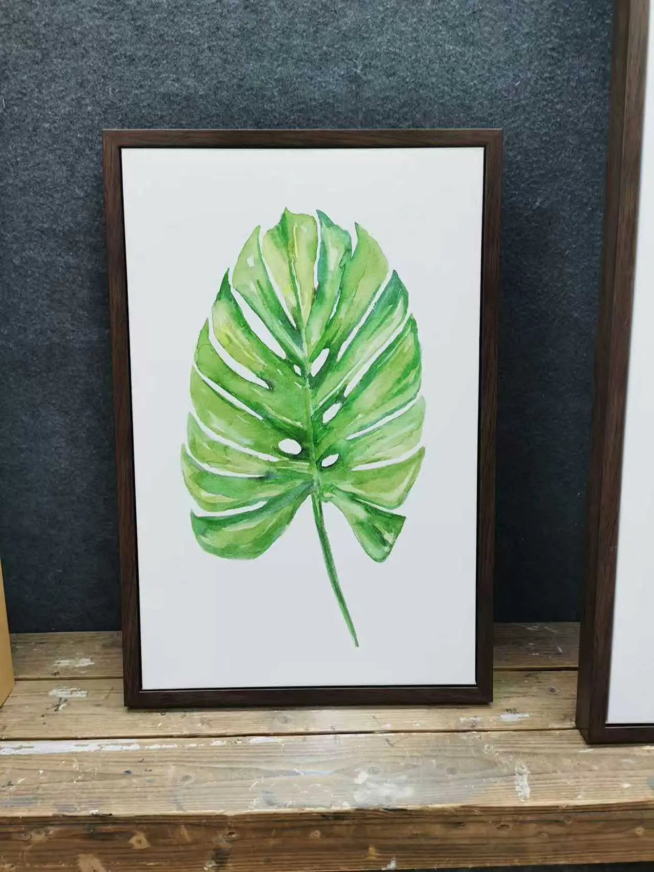 Framed tropical leaf artwork featuring green foliage, GZS sourced for hotel and residential interiors.