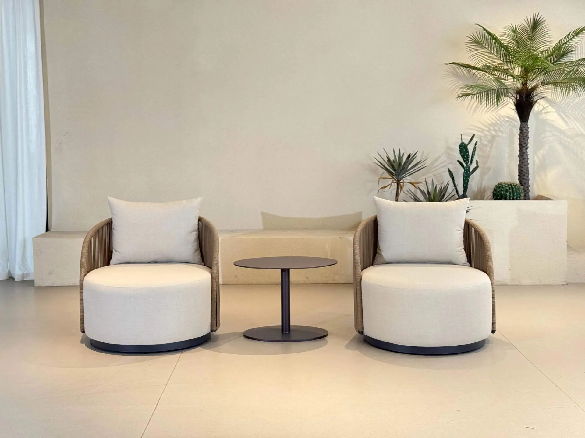 Sapphire Sands Villas lounge seating set with upholstered armchairs and side table for resort guest areas