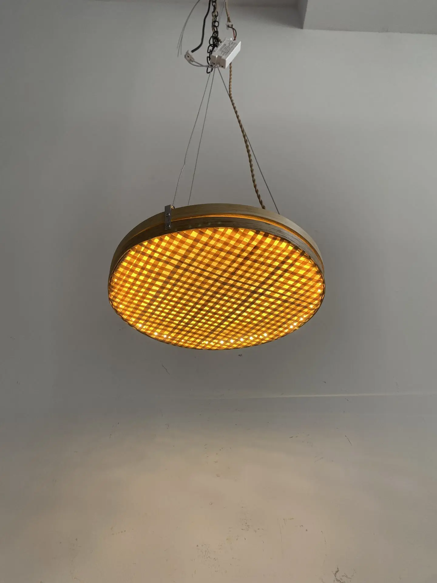 Sapphire Sands Villas round ceiling pendant light with woven diffuser and warm ambient glow