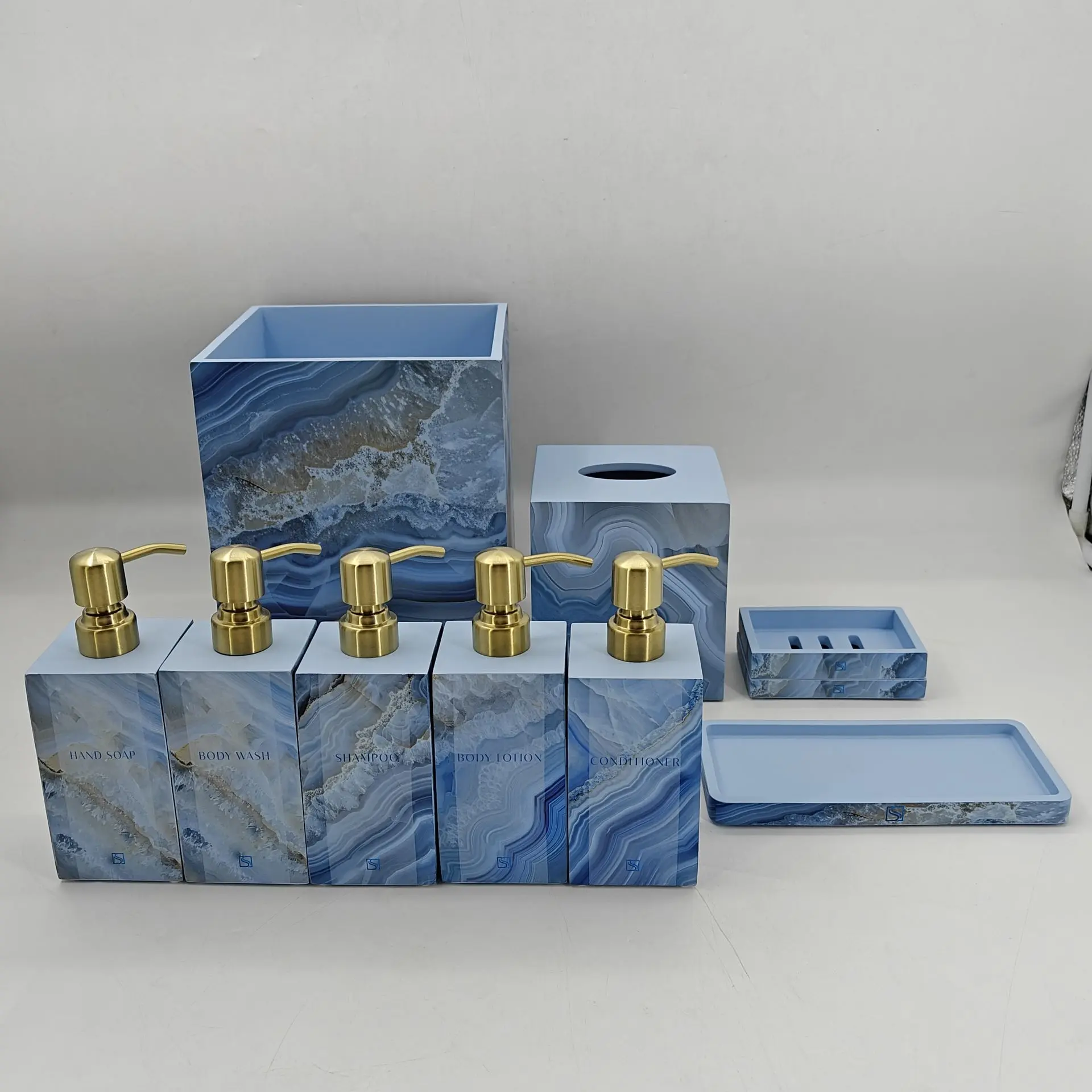 Sapphire Sands Villas bathroom amenities set with blue marble finish and gold pump dispensers, sourced by Guangzhou Sourcing