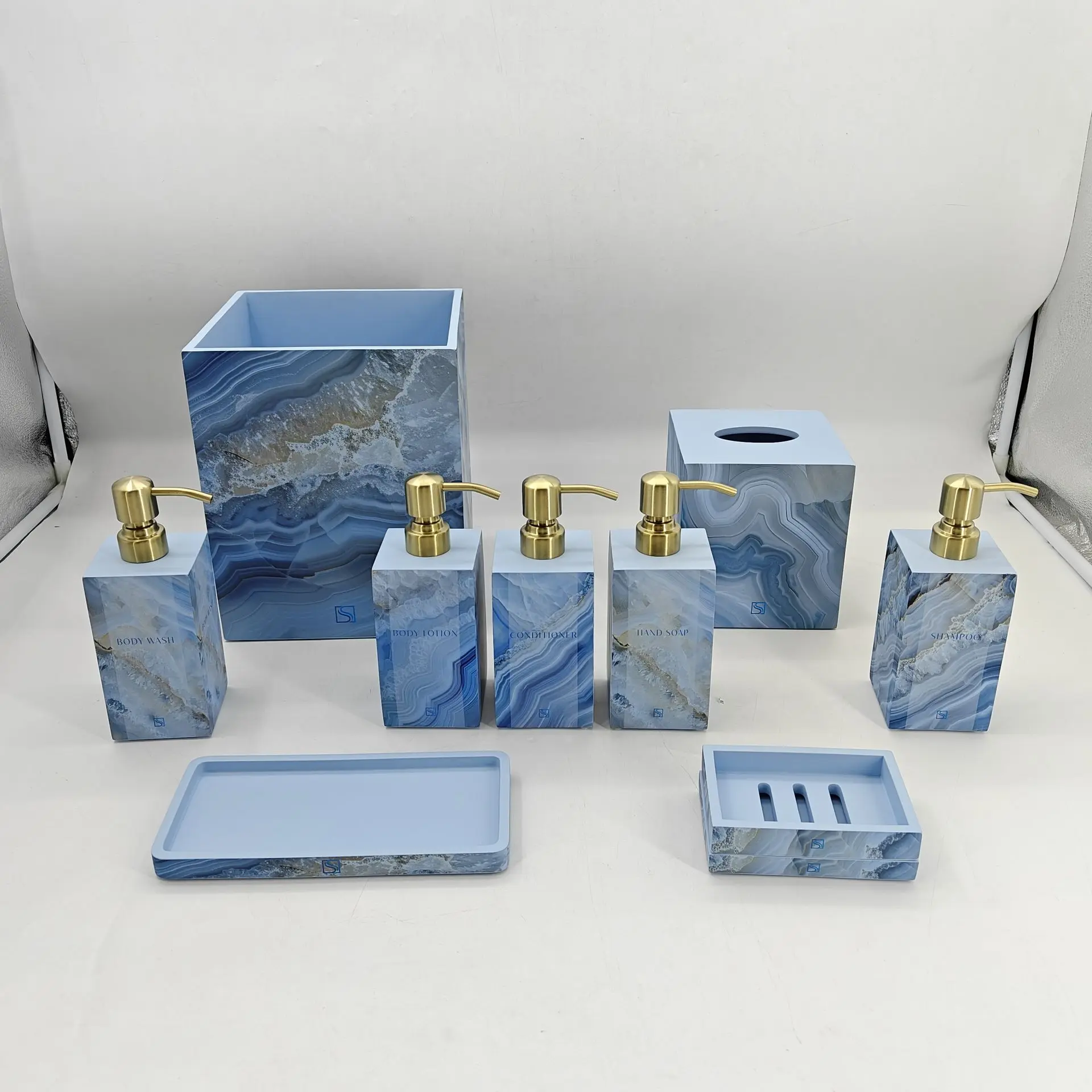 Sapphire Sands Villas bathroom accessories collection including dispensers, tray, tumbler, and tissue box