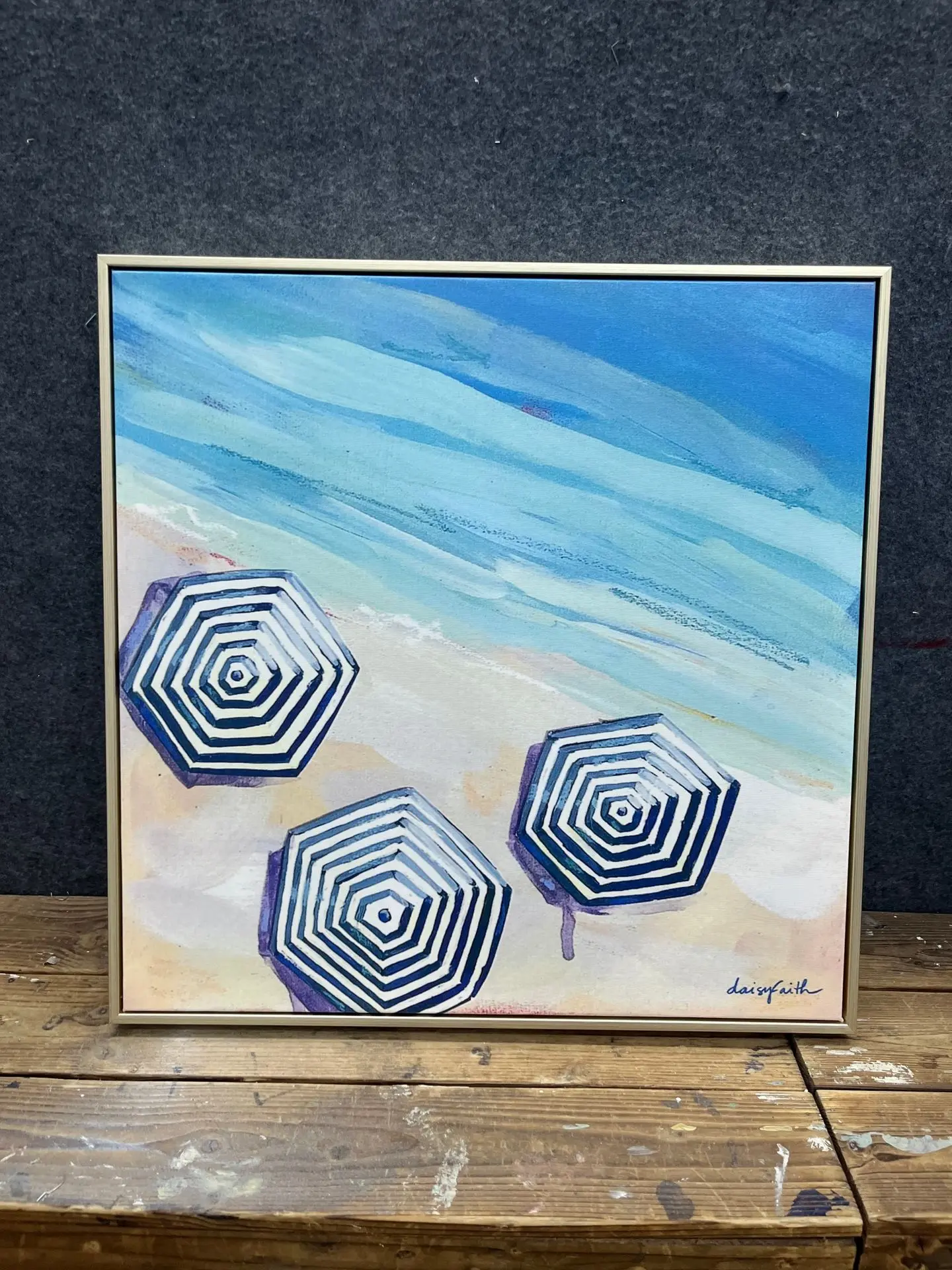 Sapphire Sands Villas coastal-themed artwork featuring beach umbrellas and ocean hues