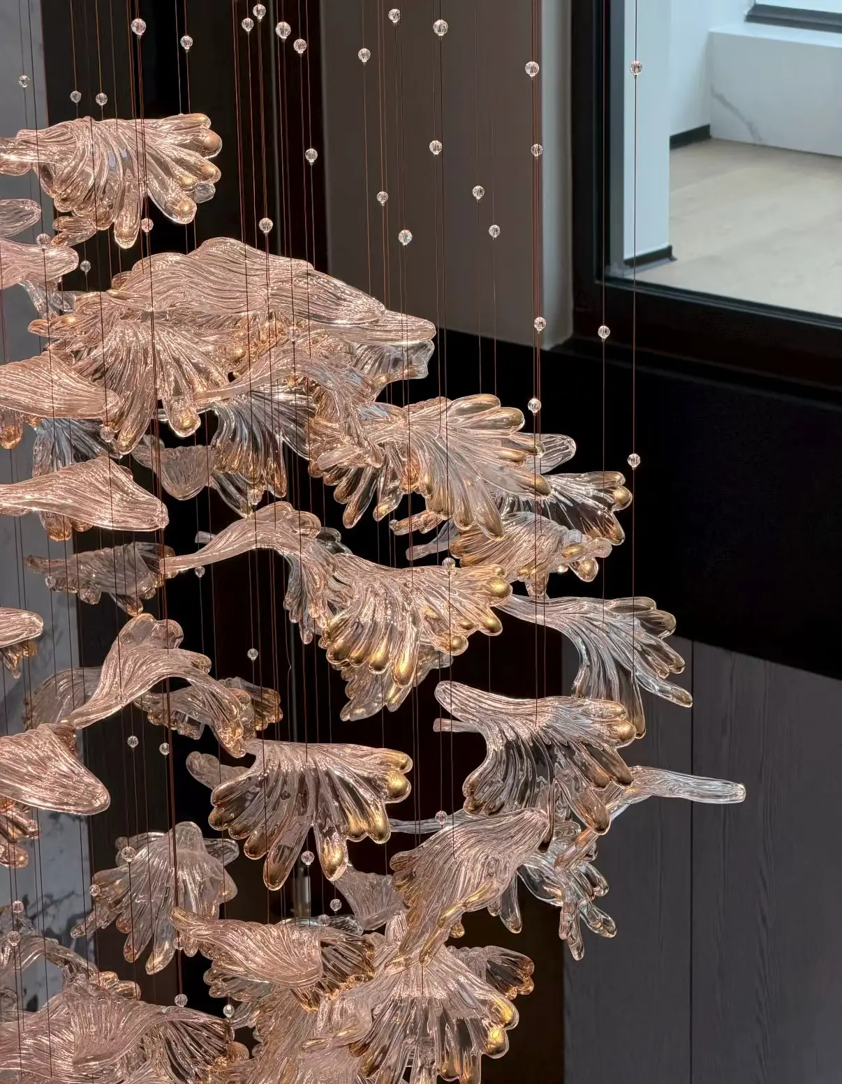 Custom-made hotel chandelier sourced from China featuring hand-formed glass elements