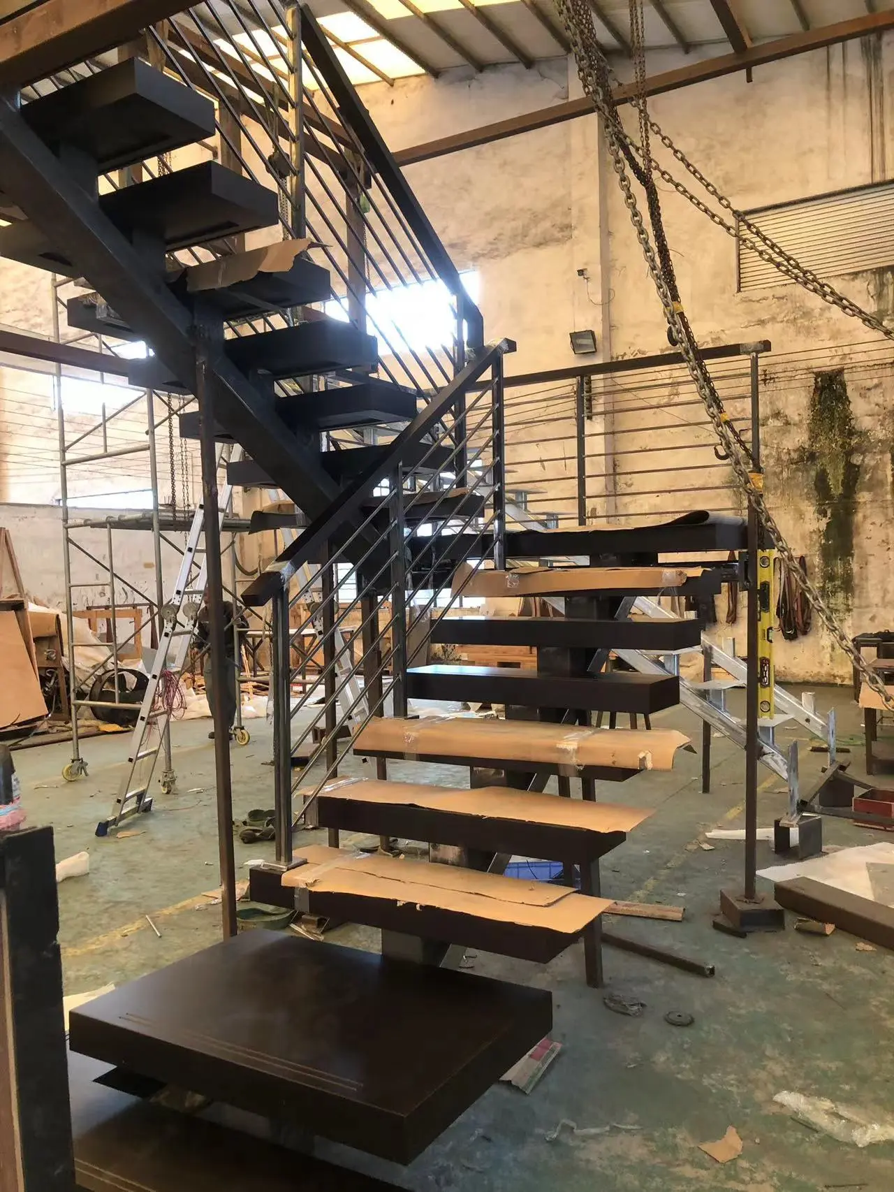 Steel staircase under fabrication in China with floating steps and metal handrail for commercial projects